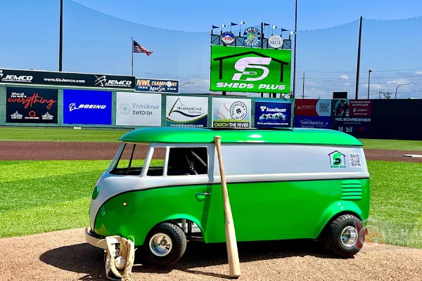 Sheds Plus sponsor billboard in the outfield grass seating at the Everett AquaSox ballpark