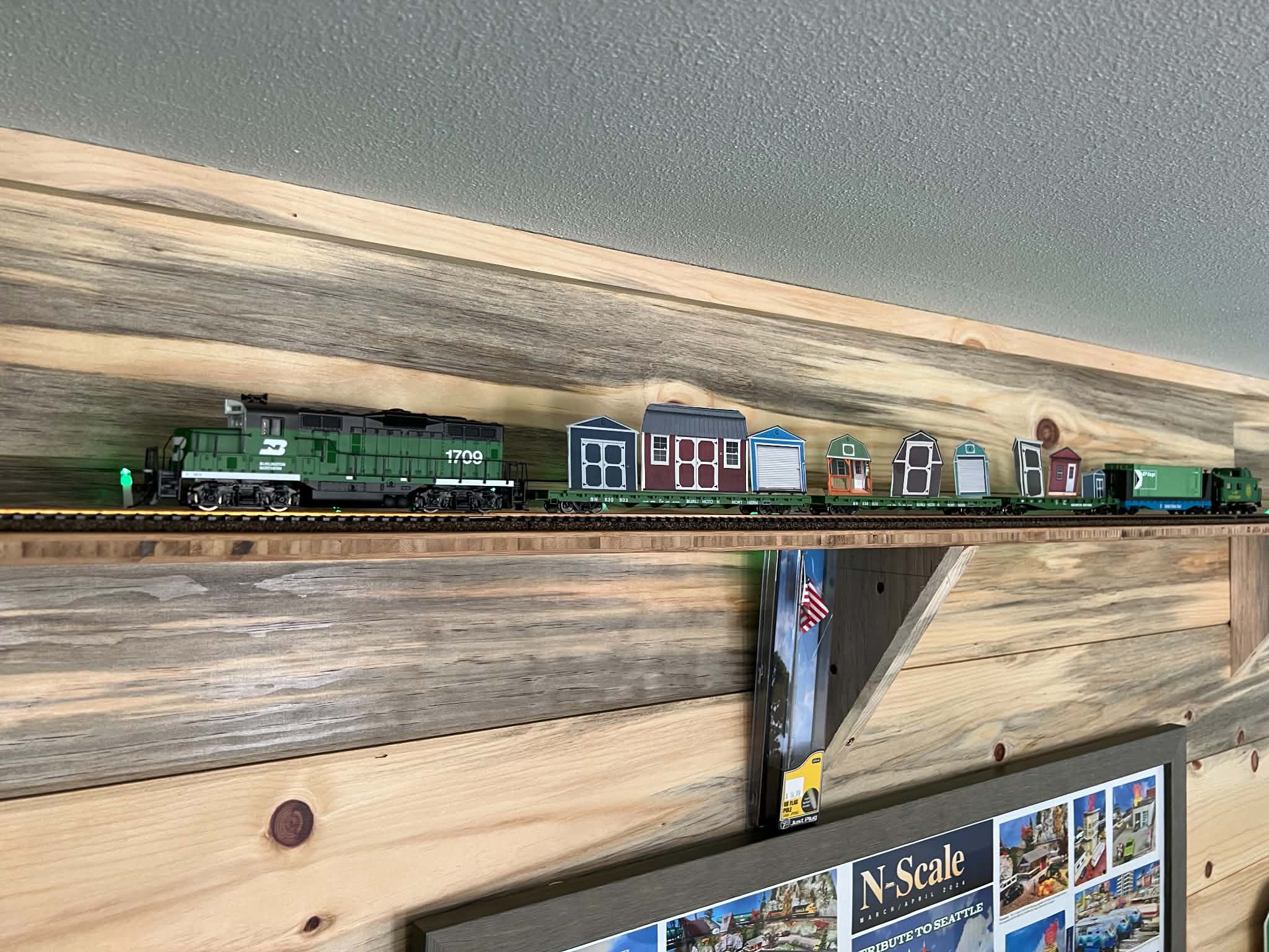 Model train running on a track around the ceiling of the Sheds Plus cabin office in Lake Stevens, WA